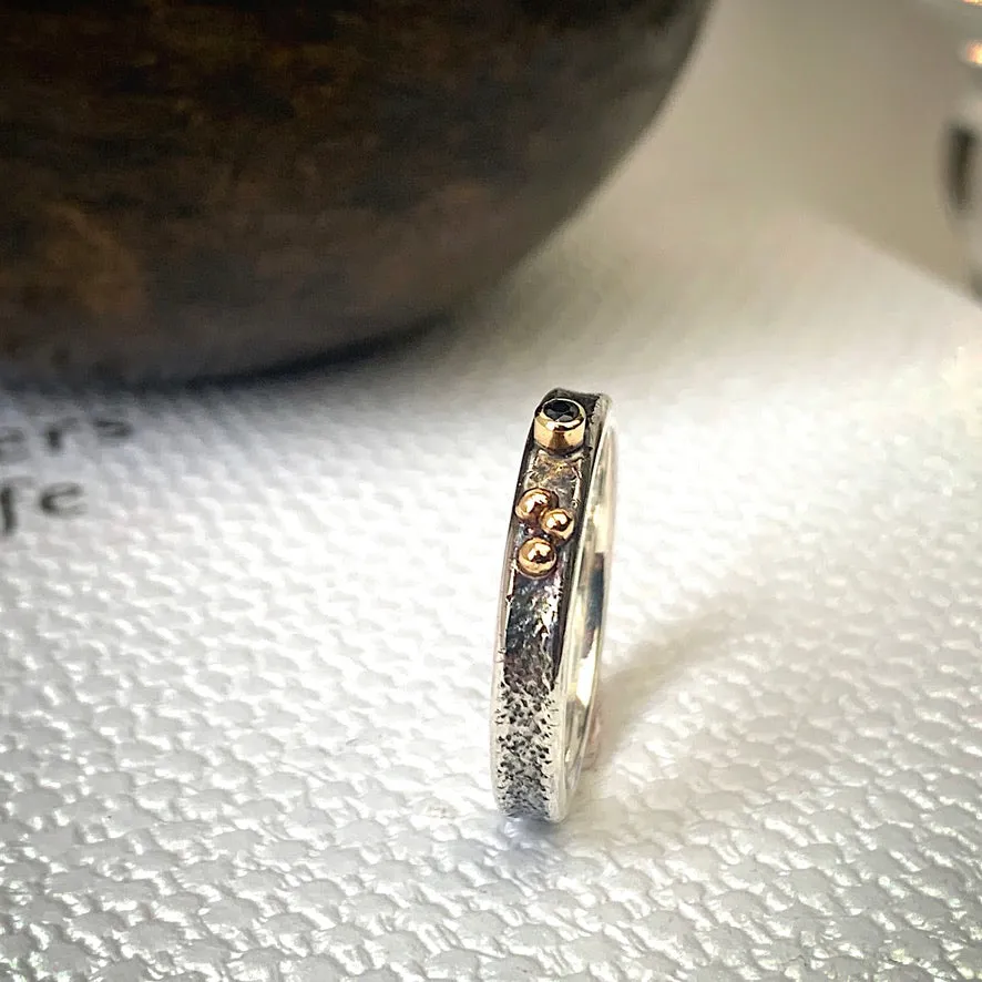 Solid sterling silver and gold ring set with a sparkling black spinel. Size O 1/2