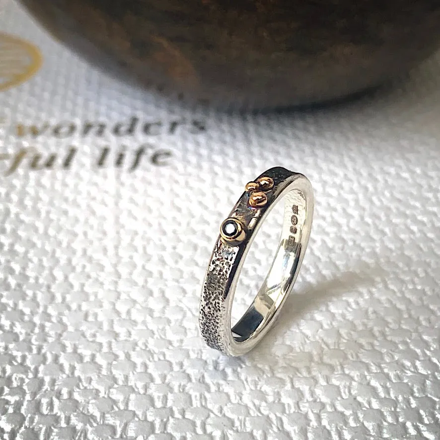 Solid sterling silver and gold ring set with a sparkling black spinel. Size O 1/2