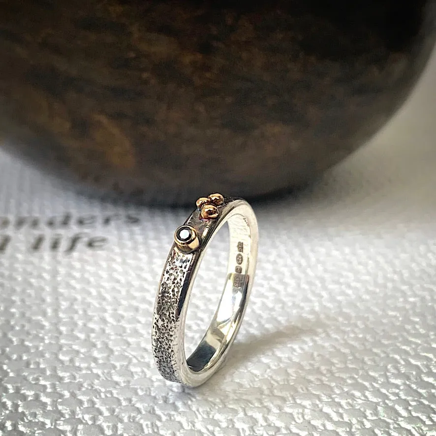 Solid sterling silver and gold ring set with a sparkling black spinel. Size O 1/2